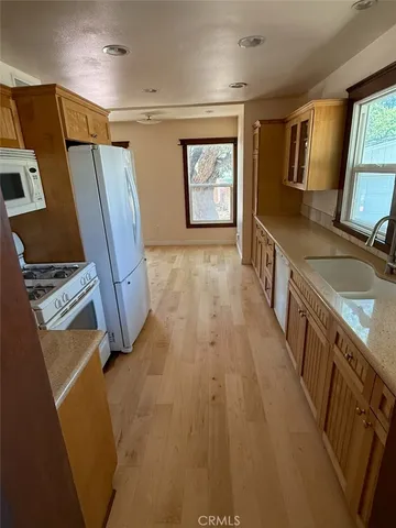 a view of an empty room with a fireplace and a window