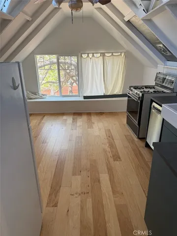 a kitchen with a refrigerator and a stove