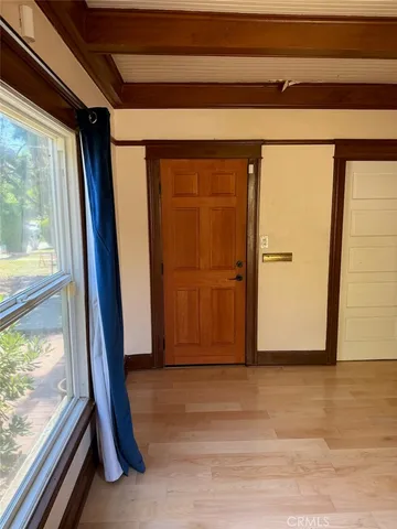 a view of a room with wooden floor