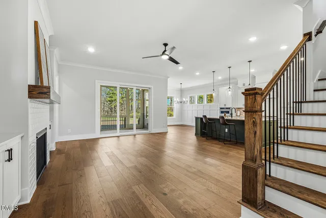 a view of a kitchen with furniture and wooden floor