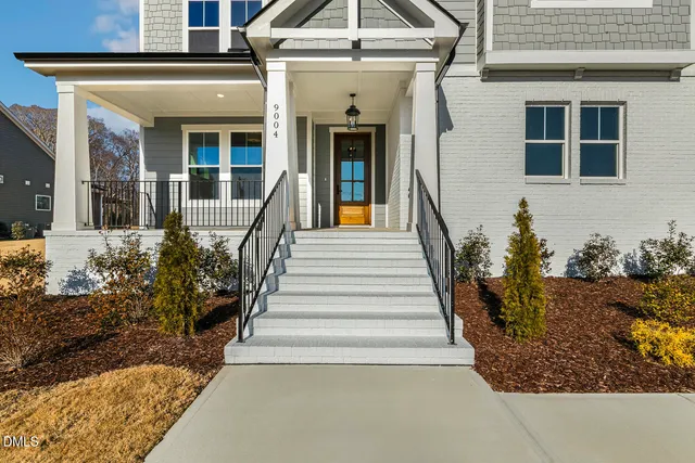 a view of a hallway with wooden floor and windows