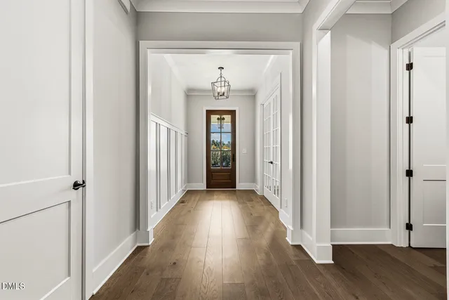 a kitchen with stainless steel appliances granite countertop a sink a stove and a wooden floor