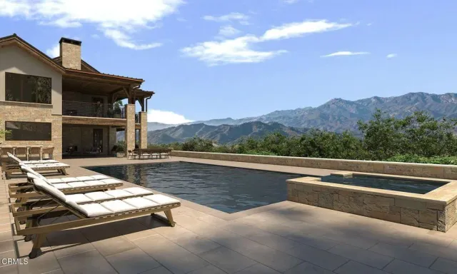 a front view of a house with swimming pool and sitting area