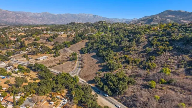 an aerial view of mountain with residential house and green space