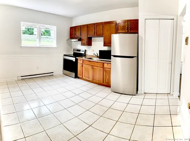 a kitchen with stainless steel appliances a refrigerator sink and cabinets