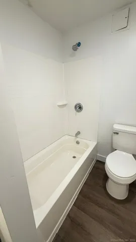 a bathroom with a toilet and a tub
