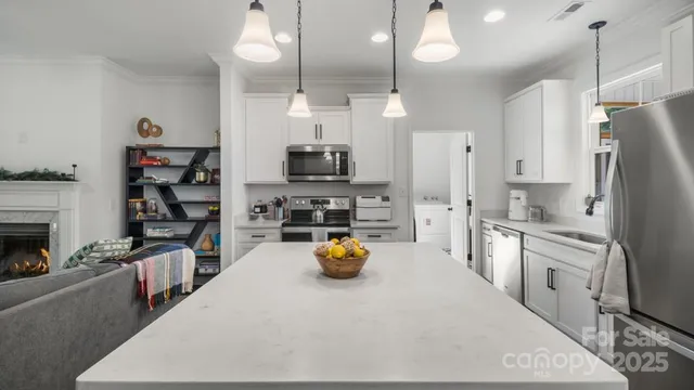 a kitchen with a stove a sink and a microwave