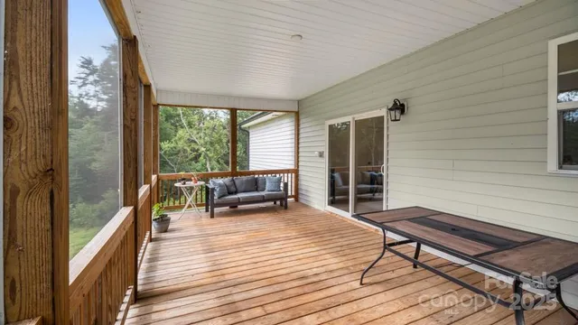 a view of a balcony with couch and wooden floor