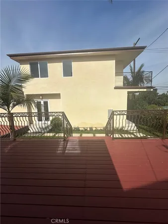 a kitchen with stainless steel appliances granite countertop a refrigerator a sink a stove and a wooden floors