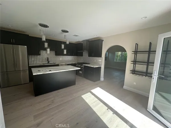 a kitchen with granite countertop white cabinets and a stove