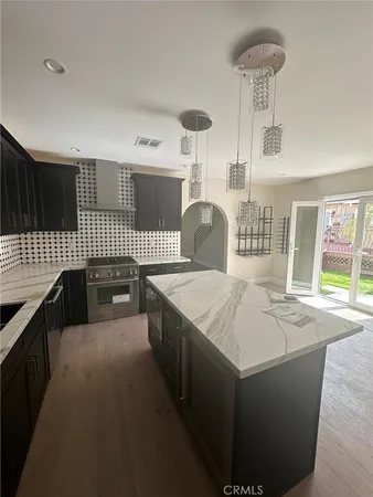 a kitchen with windows and refrigerator