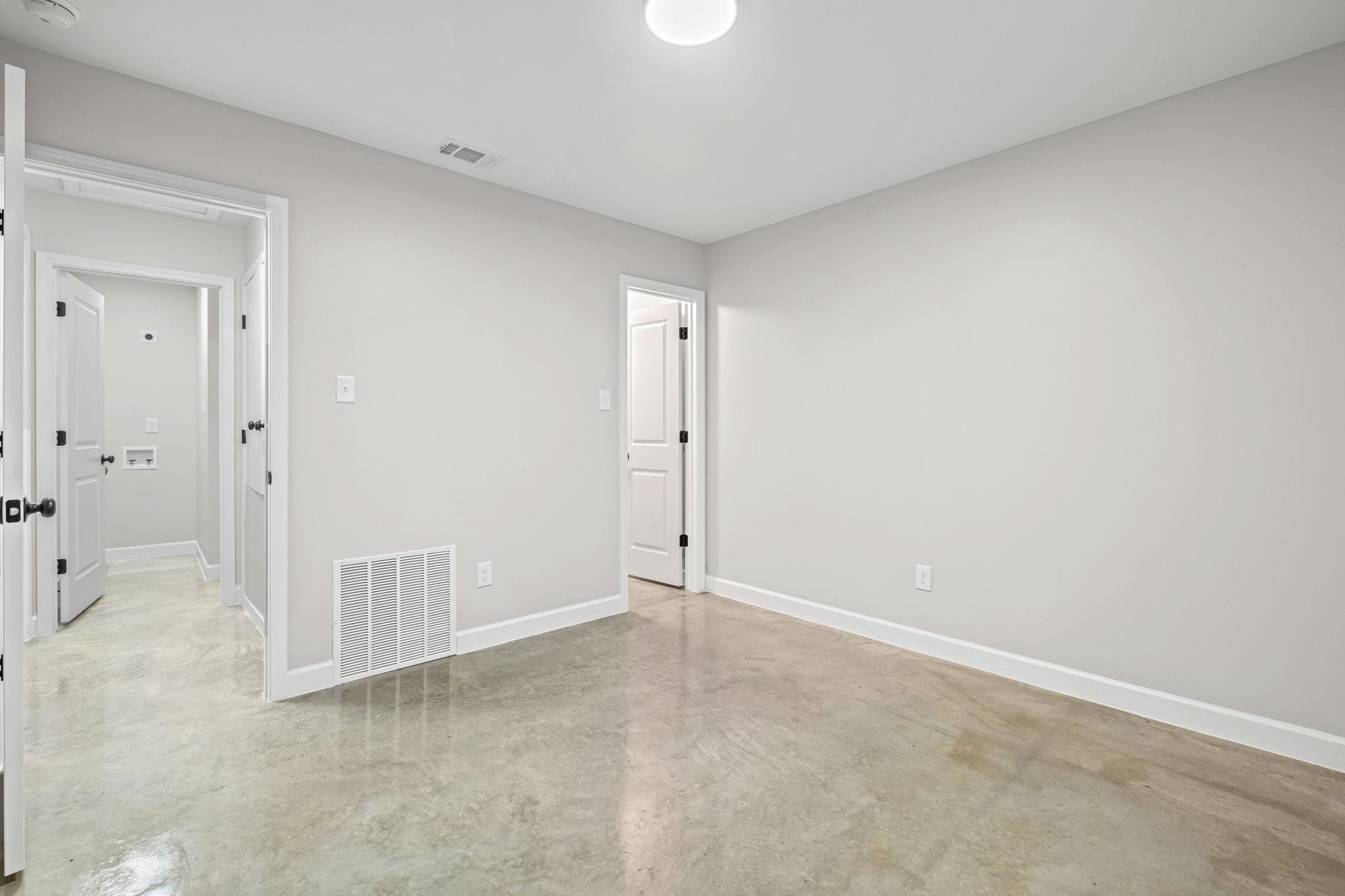 660 Gilleas Road Memphis, TN 38109 - Photo 3 of 5 an empty room with a cabinet and mirror
