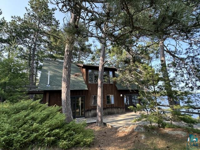 2763 Van Vac Road Ely, MN 55731 - Photo 27 of 37 Wood-sided exterior featuring an A-frame architectural element and a green-shingled roof