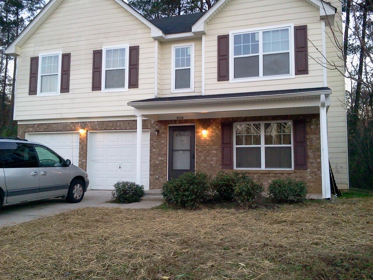 5636 Laurel Ridge Drive, Unit 12 East Point, GA 30344 - Photo 1 of 1 a front view of a house with a yard