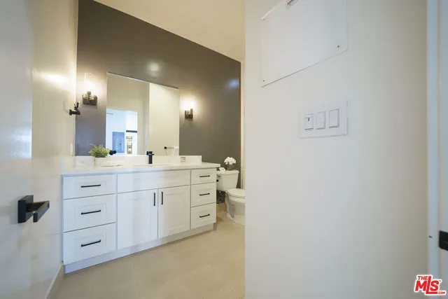 a bathroom with a double vanity sink a mirror and a bathtub