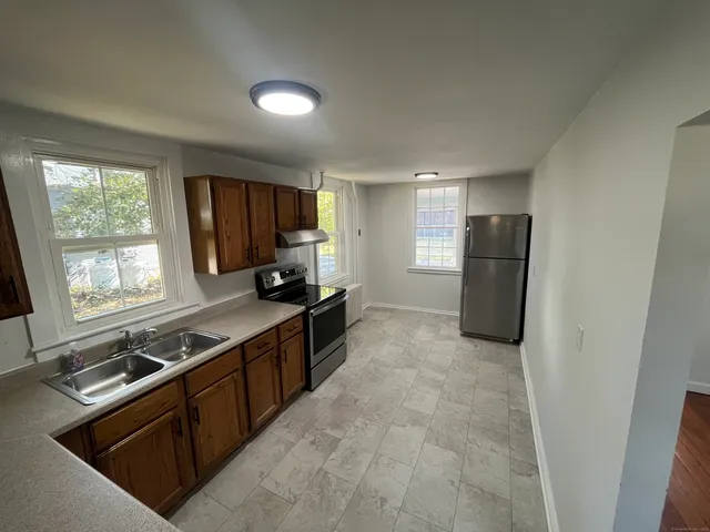 a kitchen with a sink stove and refrigerator