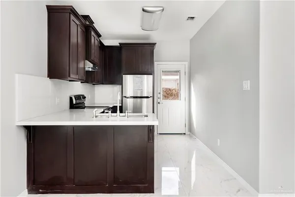 a kitchen with a sink and cabinets