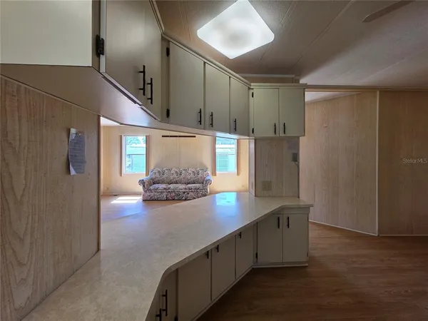 a view of empty room with cabinet and floor to ceiling window