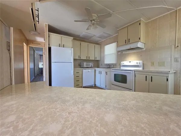 a view of a kitchen with a sink and cabinet area
