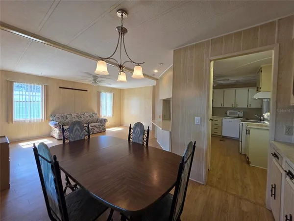 a view of a livingroom with furniture and a kitchen