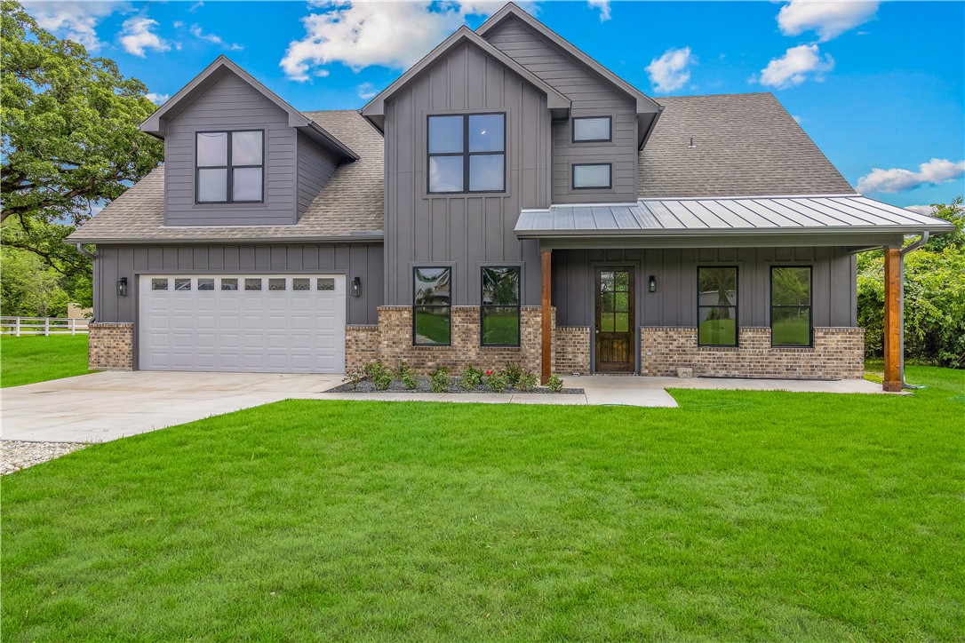 13291 Hopes Creek Road College Station, TX 77845 - Photo 38 of 45 Modern farmhouse style home featuring board and batten siding, a shingled roof, driveway, and covered porch