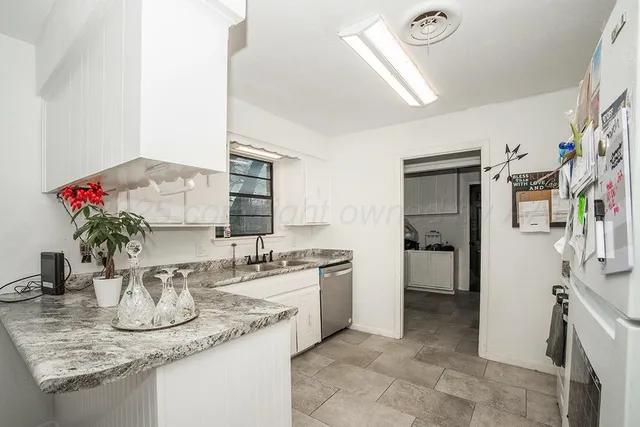 a kitchen with a sink and cabinets
