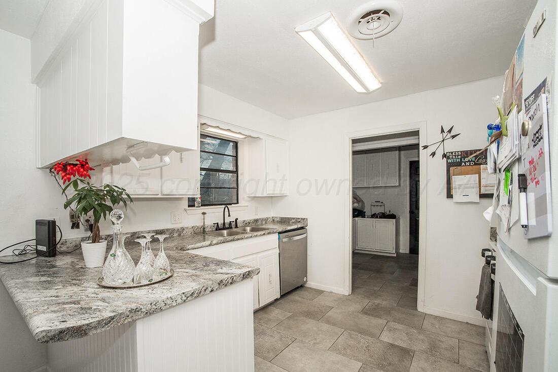 4206 Arden Road Amarillo, TX 79110 - Photo 12 of 26 a kitchen with a sink and cabinets