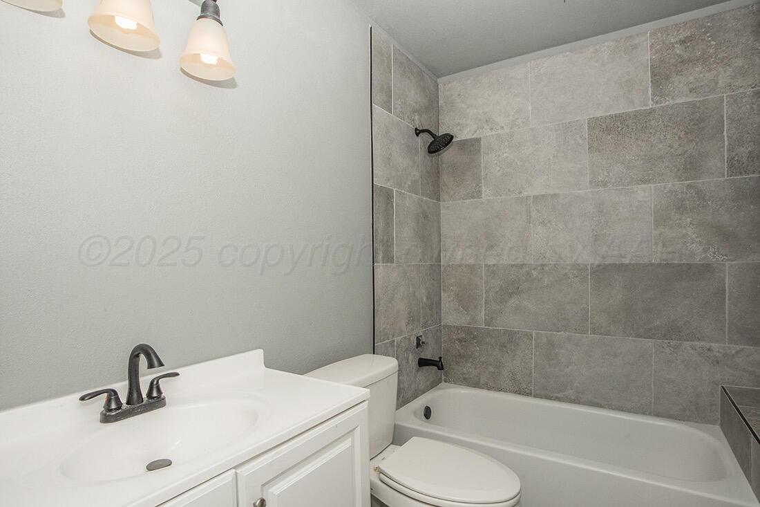 4206 Arden Road Amarillo, TX 79110 - Photo 15 of 26 a bathroom with a sink toilet and bathtub