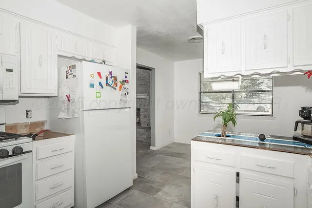 a white refrigerator freezer sitting inside of a kitchen