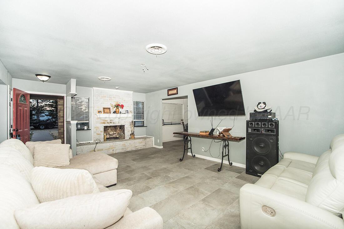 4206 Arden Road Amarillo, TX 79110 - Photo 3 of 26 a living room with furniture and a flat screen tv