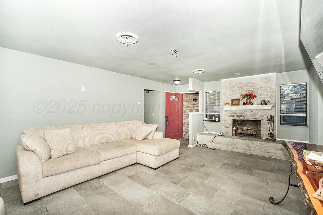 4206 Arden Road Amarillo, TX 79110 - Photo 4 of 26 a living room with furniture and a fireplace