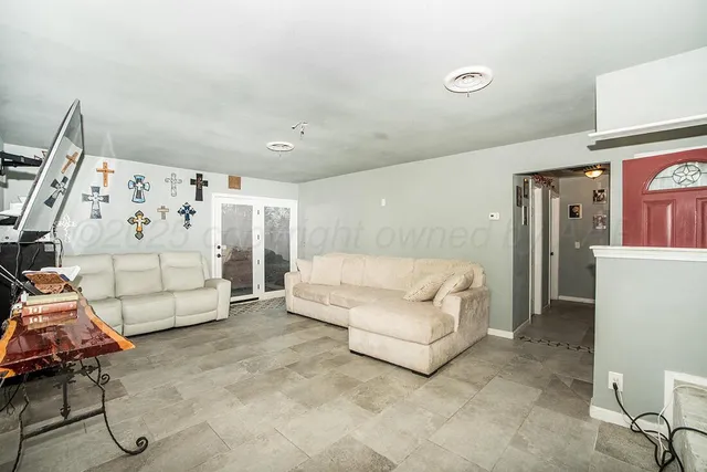 a living room with furniture and white walls