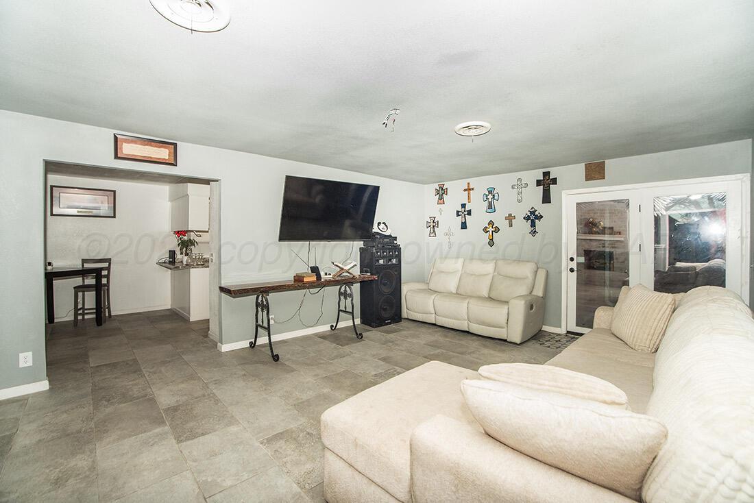 4206 Arden Road Amarillo, TX 79110 - Photo 6 of 26 a living room with furniture and a flat screen tv