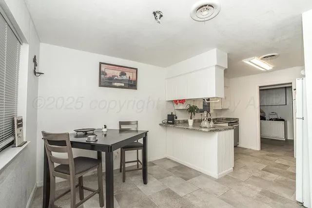 a kitchen with a table and chairs in it