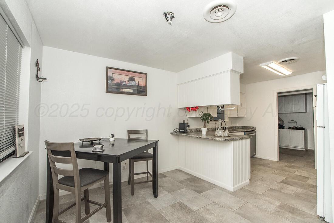 4206 Arden Road Amarillo, TX 79110 - Photo 9 of 26 a kitchen with a table and chairs in it