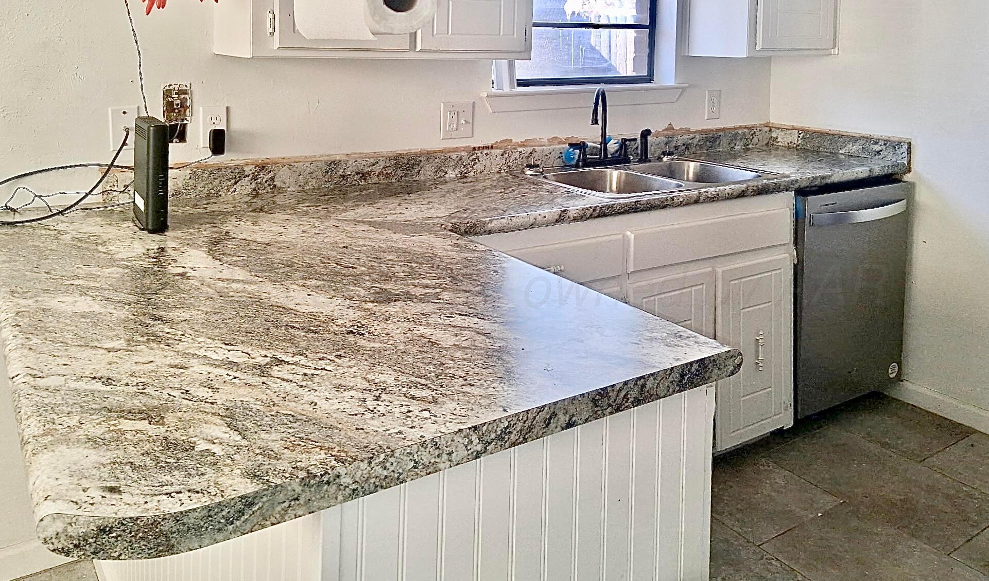 4206 Arden Road Amarillo, TX 79110 - Photo 10 of 26 a kitchen with a sink and cabinets