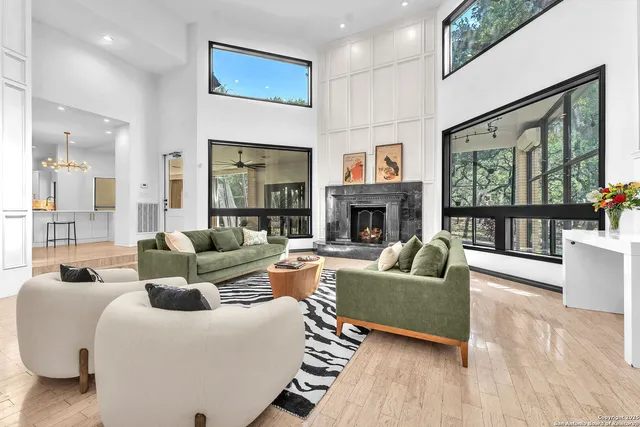 a large white kitchen with a refrigerator a stove a dining table and chairs