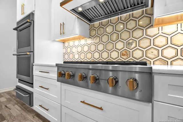 a view of an empty room with a window and kitchen view