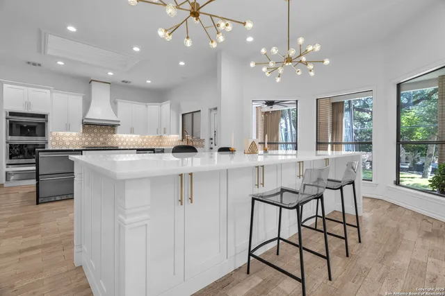 a living room with furniture and large windows