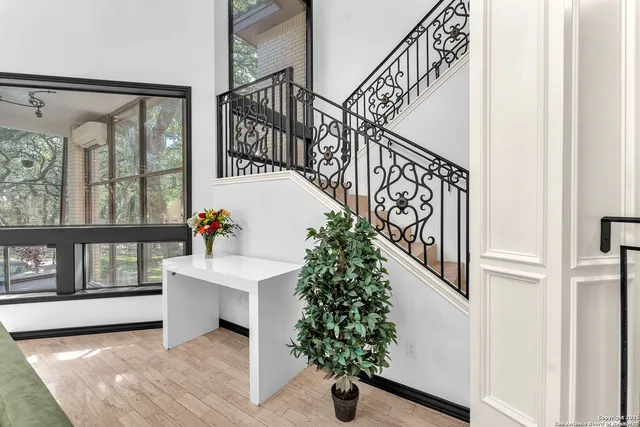 a kitchen with white cabinets and window
