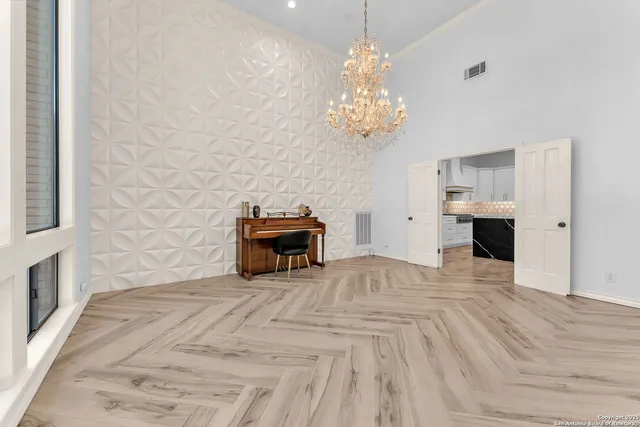 a view of a hallway with wooden floor and a bathroom