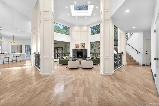 a kitchen with kitchen island granite countertop a sink cabinets and dining table