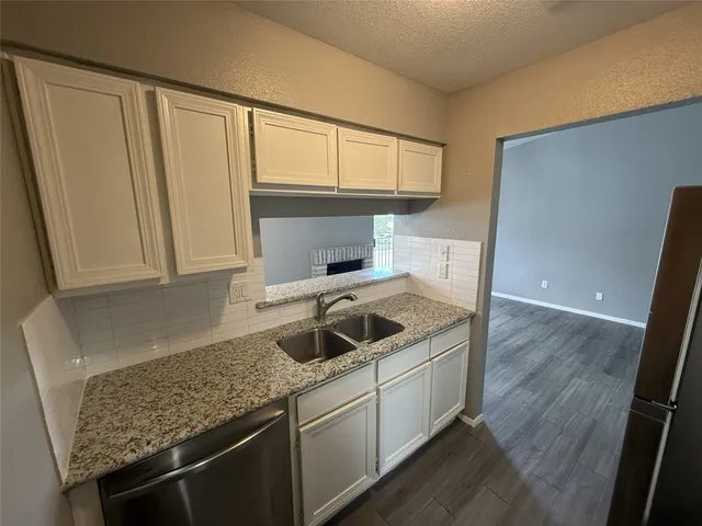 a kitchen with a sink stove and cabinets