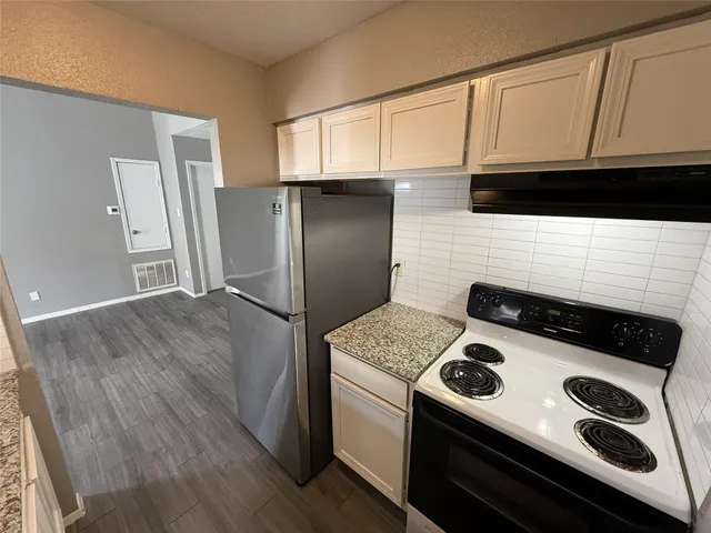 a kitchen with a stove and a microwave