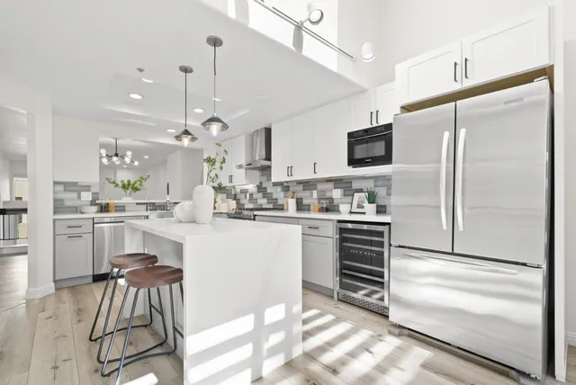 a kitchen with white cabinets and stainless steel appliances