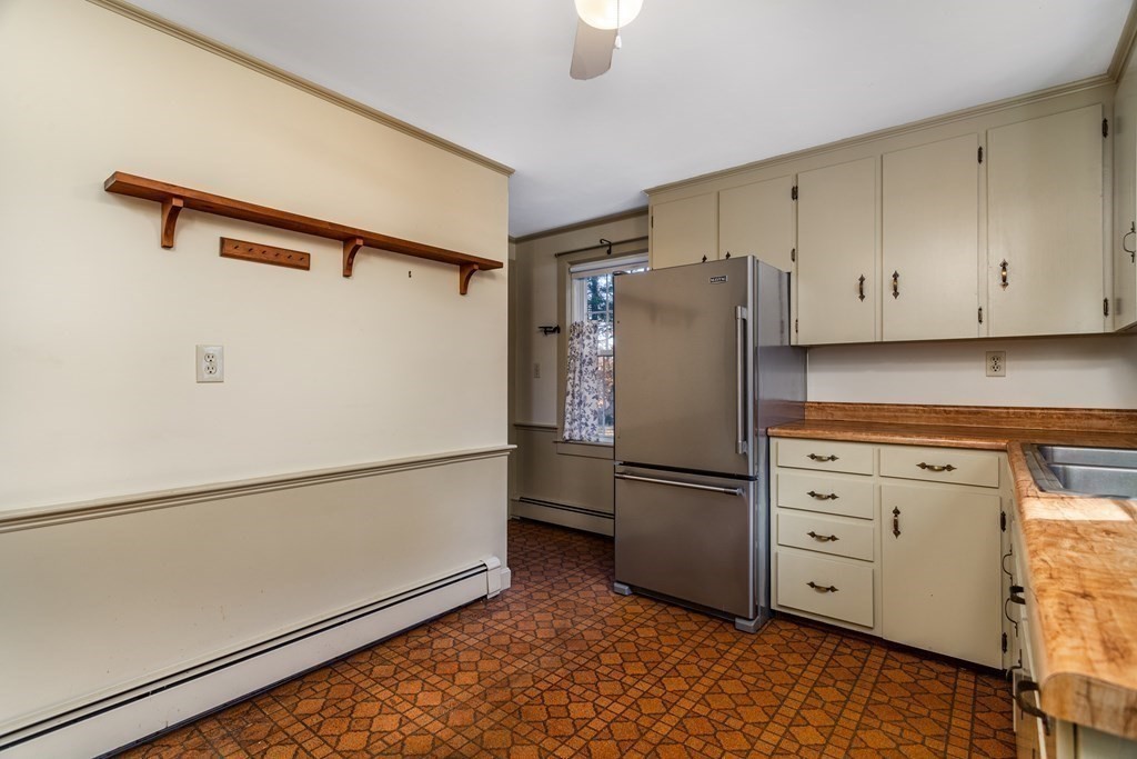 589 Turnpike Road Ashby, MA 01431 - Photo 14 of 40 a white refrigerator freezer and a stove sitting inside of a kitchen
