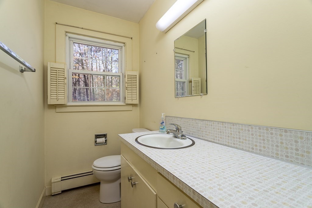 589 Turnpike Road Ashby, MA 01431 - Photo 27 of 40 a bathroom with a granite countertop sink mirror and toilet