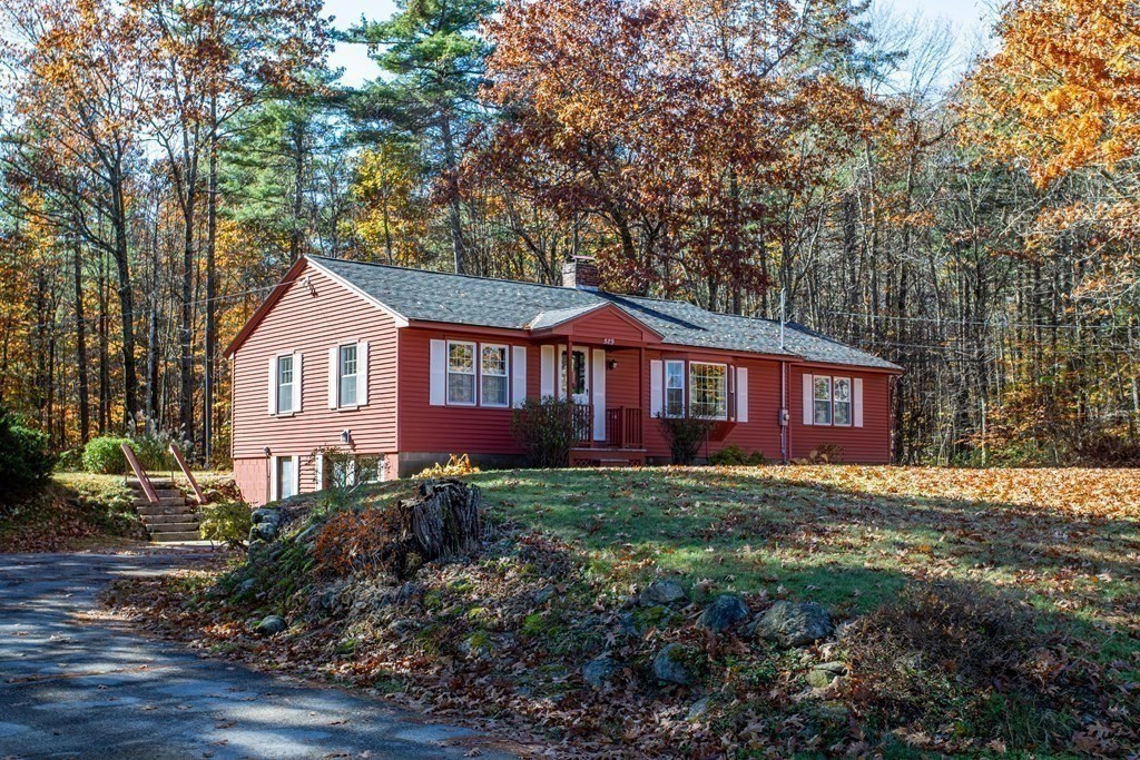 589 Turnpike Road Ashby, MA 01431 - Photo 29 of 40 a view of a yard in front of a house with plants and large trees