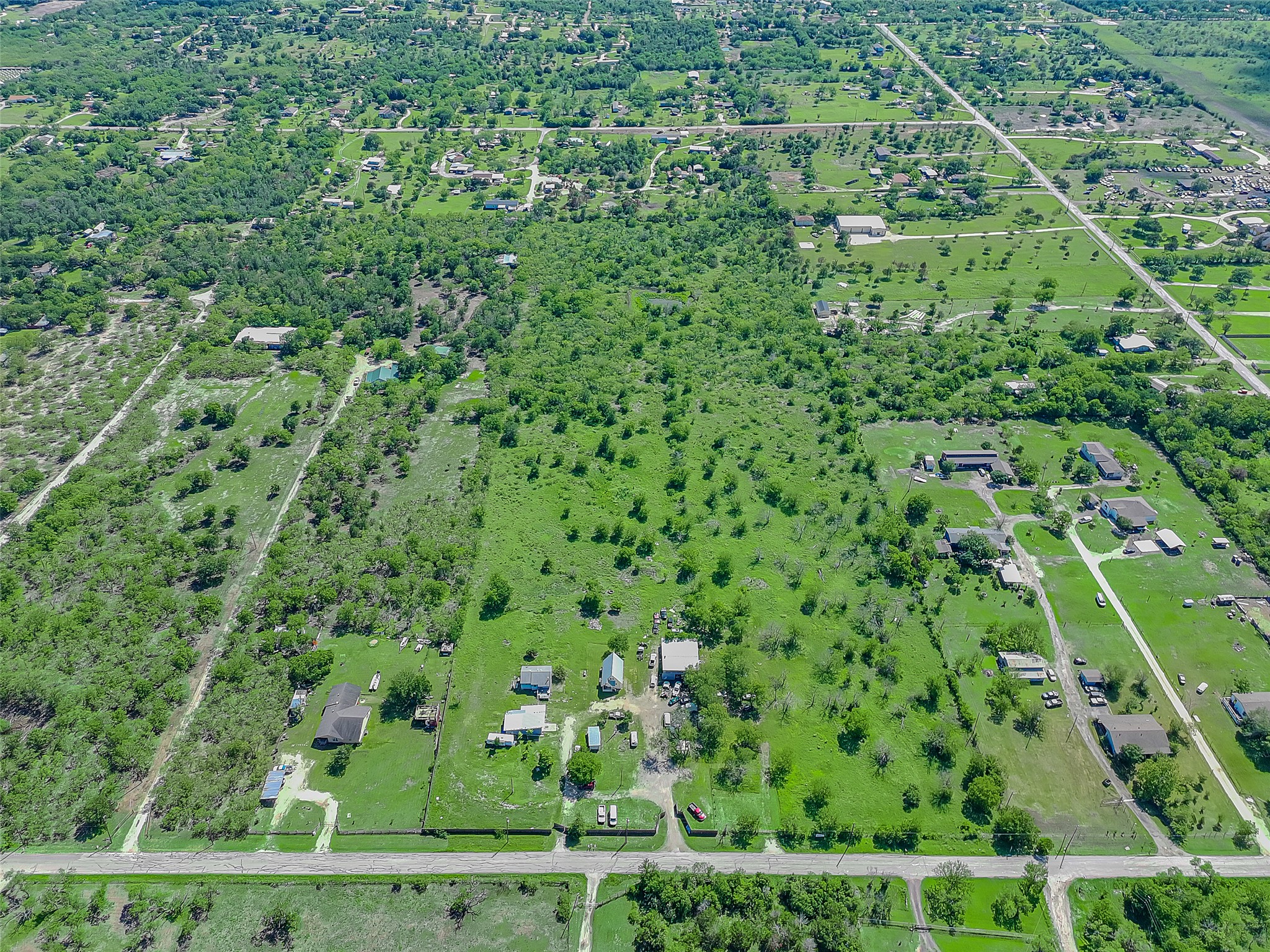 925 Long Hollow Road Dale, TX 78616 - Photo 26 of 26 Expansive acreage property featuring diverse vegetation, scattered residential structures, and established road access