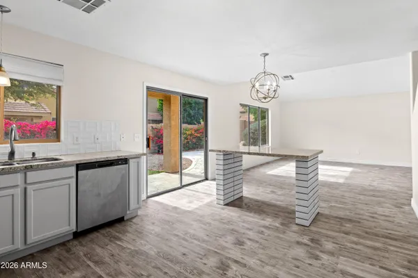 a living room with granite countertop furniture and a chandelier